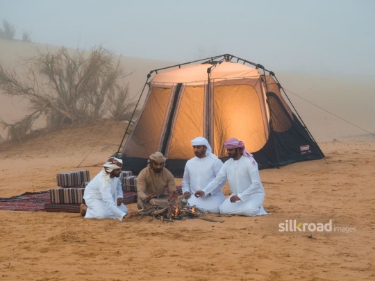 Men sitting outside in fog