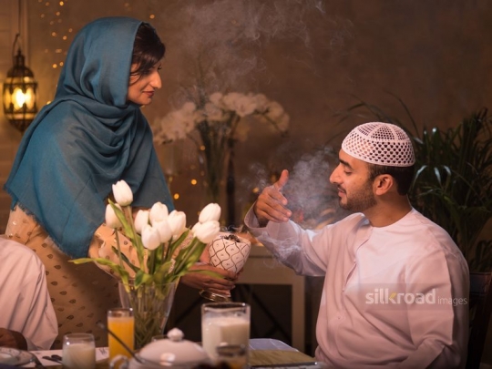 Wife perfuming husband|-