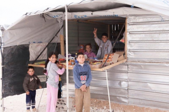 small shop and kids trying to buy and sell from Zaatari refugee camp for Syrian refugees