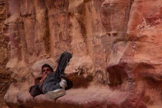 Bedouin boy lying in Rose City, Petra, Jordan