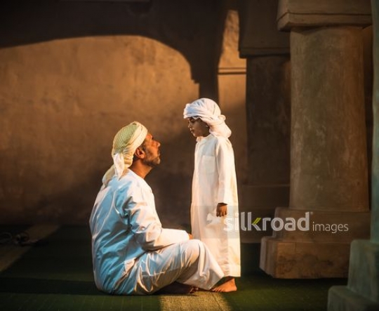 Oldman in conversation with kid at the mosque|-
