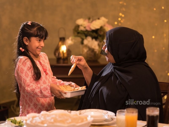 Granddaughter serving puff pastry|-