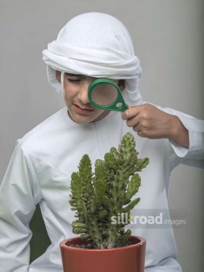 Arabian boy looking through his magnifier