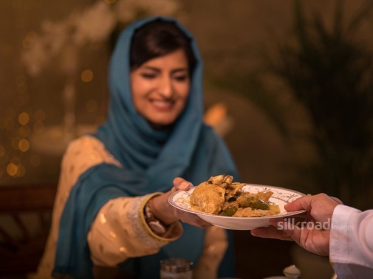 Woman taking plate|-