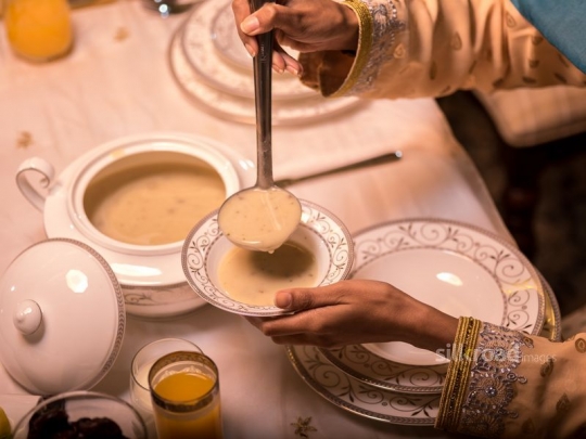 Mother pouring soup|-