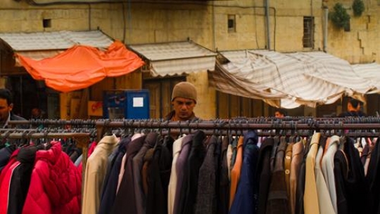 -Man browsing clothes in bazar