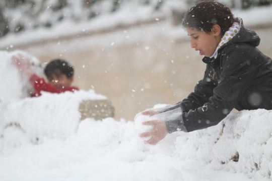 Fresh snow cover, at winter in Palestine, everbody happy and outside and play in the snow