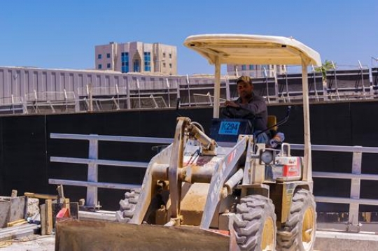 construction worker driving a bulldozer on a construction site