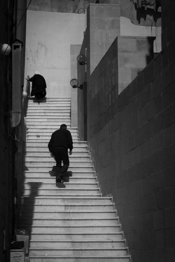 View of the town of Salt in Jordan, Man and old women walking up stairs