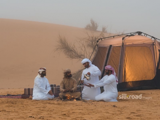 man serving with coffee pot