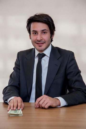 businessman putting hand on a bunch of money