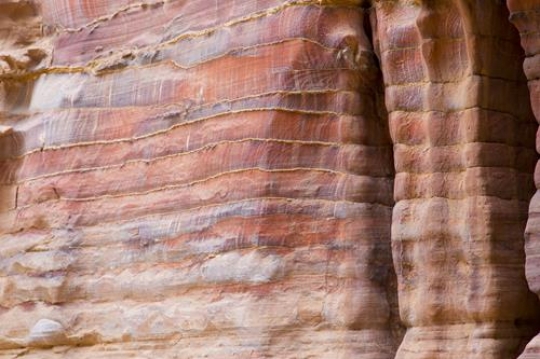 Abstract layered sandstone wall in world wonder Petra, Jordan