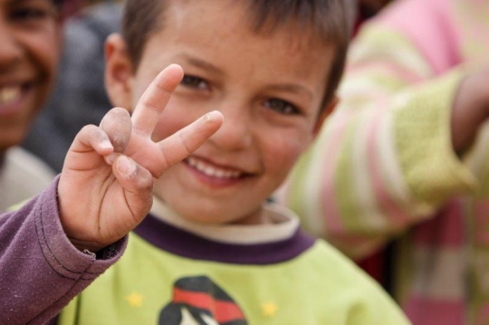 kid showing victory sign