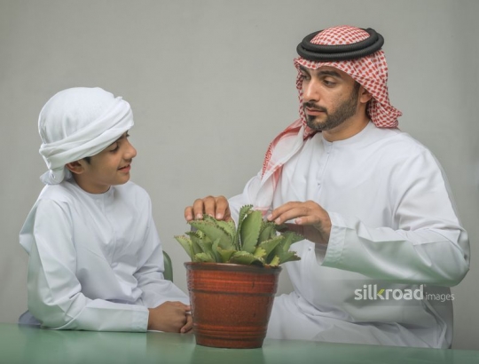 father and son sharing information about plants