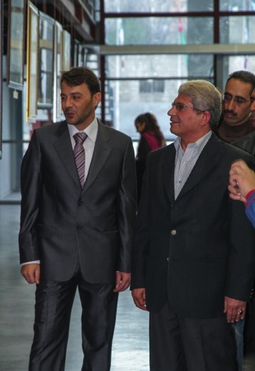 men in suites looking at somet