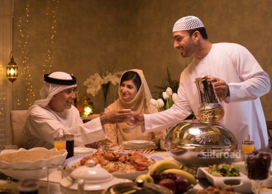 Man serving Arabic coffee|-