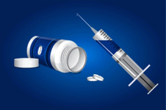 Medication,pills and syringe on blue background