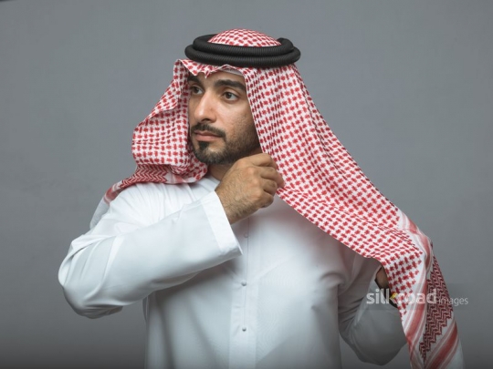 Arabian Man fitting his traditional head cover
