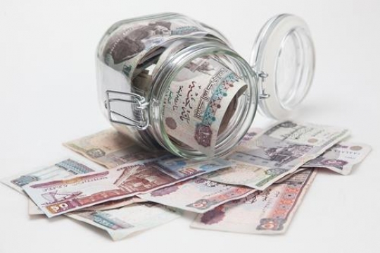 money in the glass saving jar