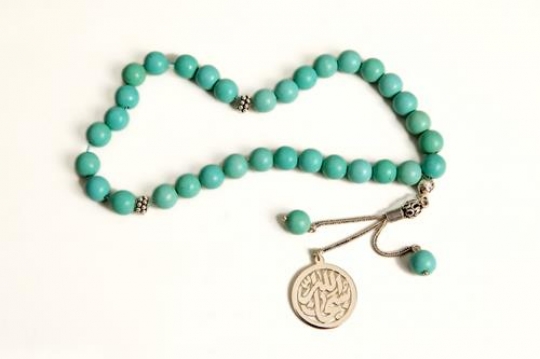 close-up of a turquoise islamic rosary