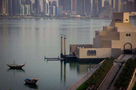 view of museum of islamic art at night,with the dafna over the harbor