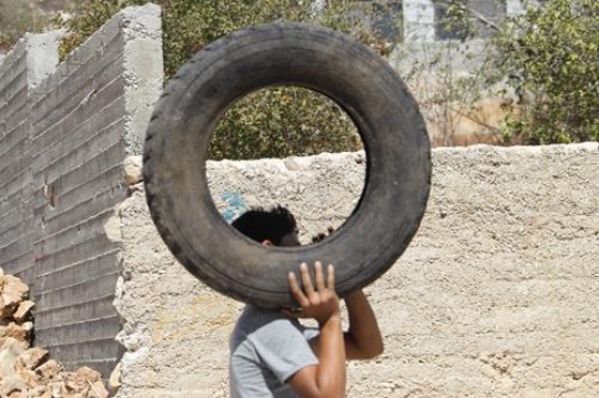 young man holding tire