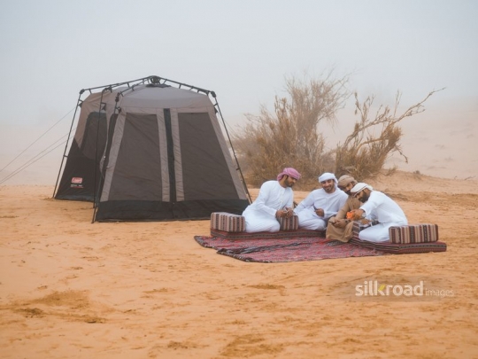 Friends taking a selfie in the desert camp
