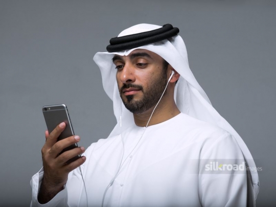 Man reading messages off of his mobile phone