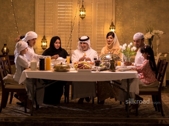 Family around dining table|-