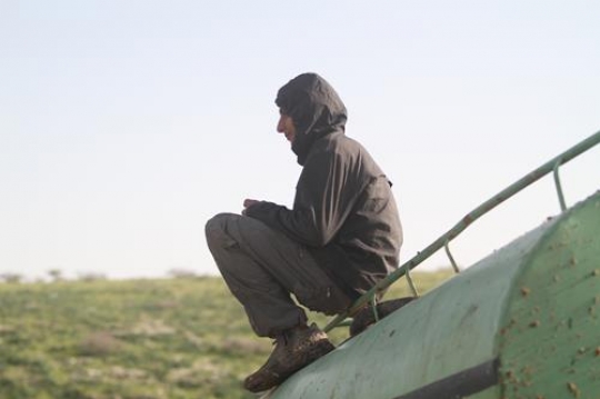 Boy sitting on water tank