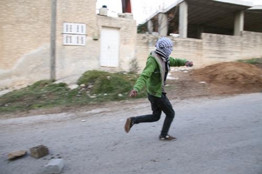 palestinian young man throwing stones