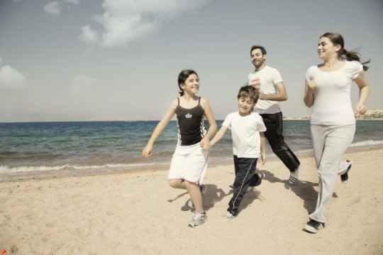 Family Running by the Sea
