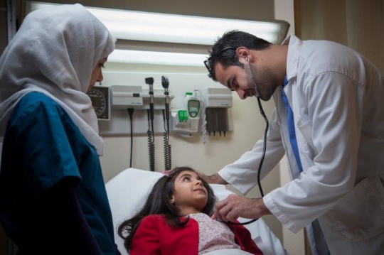Doctor Examining Little Girl at ER