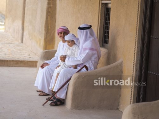 Grandfather giving money to children|-