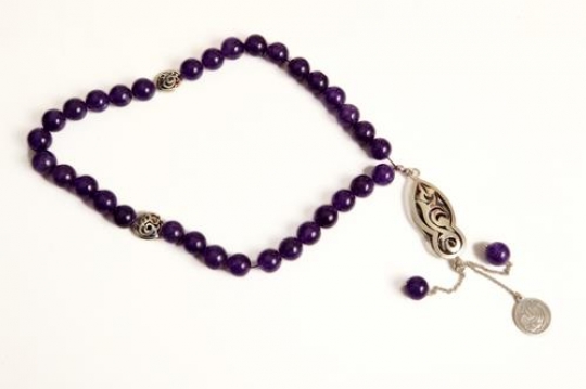 close-up of a purple islamic rosary
