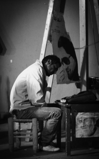 man looking at a portrait in black and white