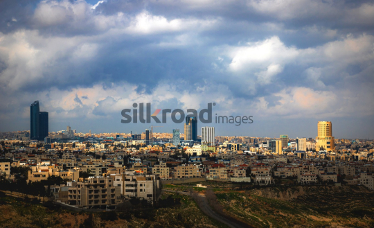 Amman Cityscape: Modern Towers Amidst Cloudy Skies