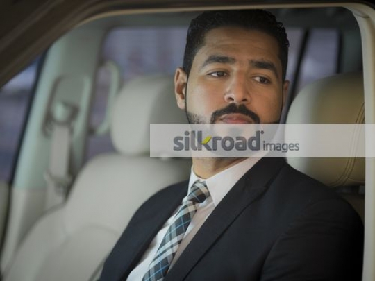 Arab Businessman sitting inside the car|