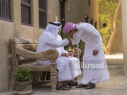 Arab son kissing his grandfathers hand|-