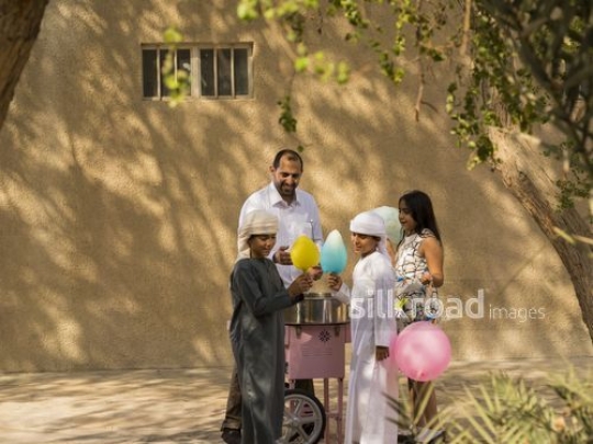 Arab kids taking cotton candy from the man|-