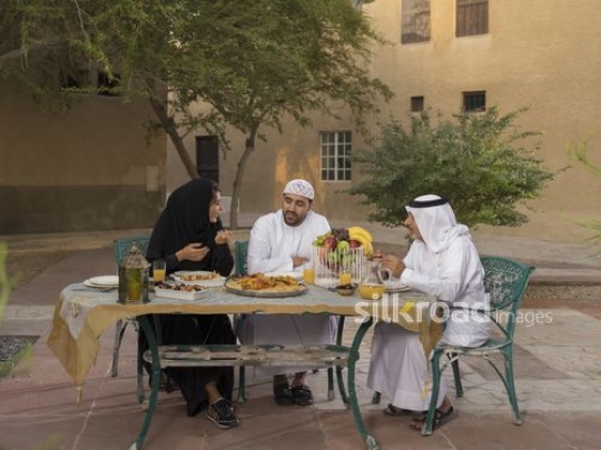 REPLACE - Arab family sitting together waiting to have Iftar|-