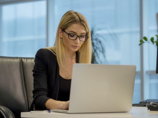 Business woman typing on the keyboard of the laptop|