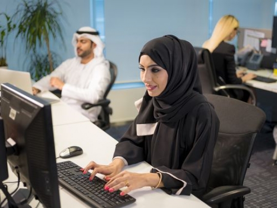 Business woman sitting by her desk|