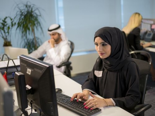 Business people sitting by their desks at the office|