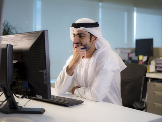 Business man sitting by his desk |