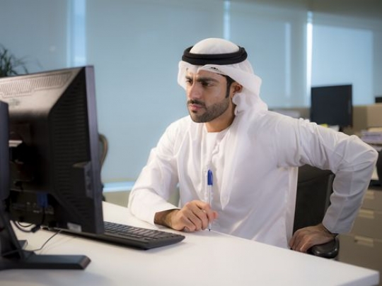 Serious business man sitting by his desk|