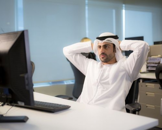 Business man leaning back on his chair|