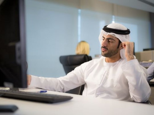 Business man sitting by the desk working |
