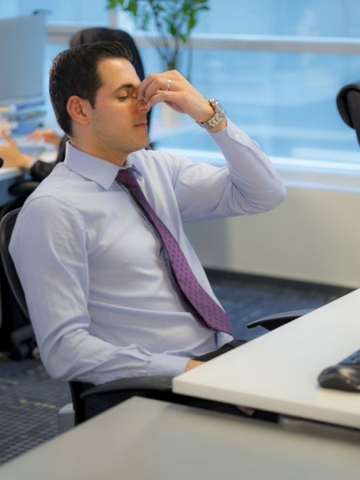Employee has a headache while sitting at the desk|-