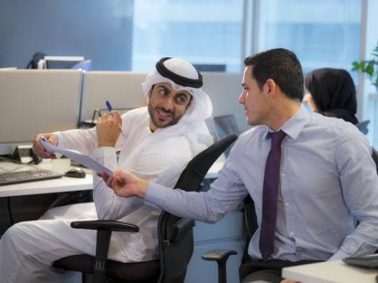 Employee handing his colleague papers|-